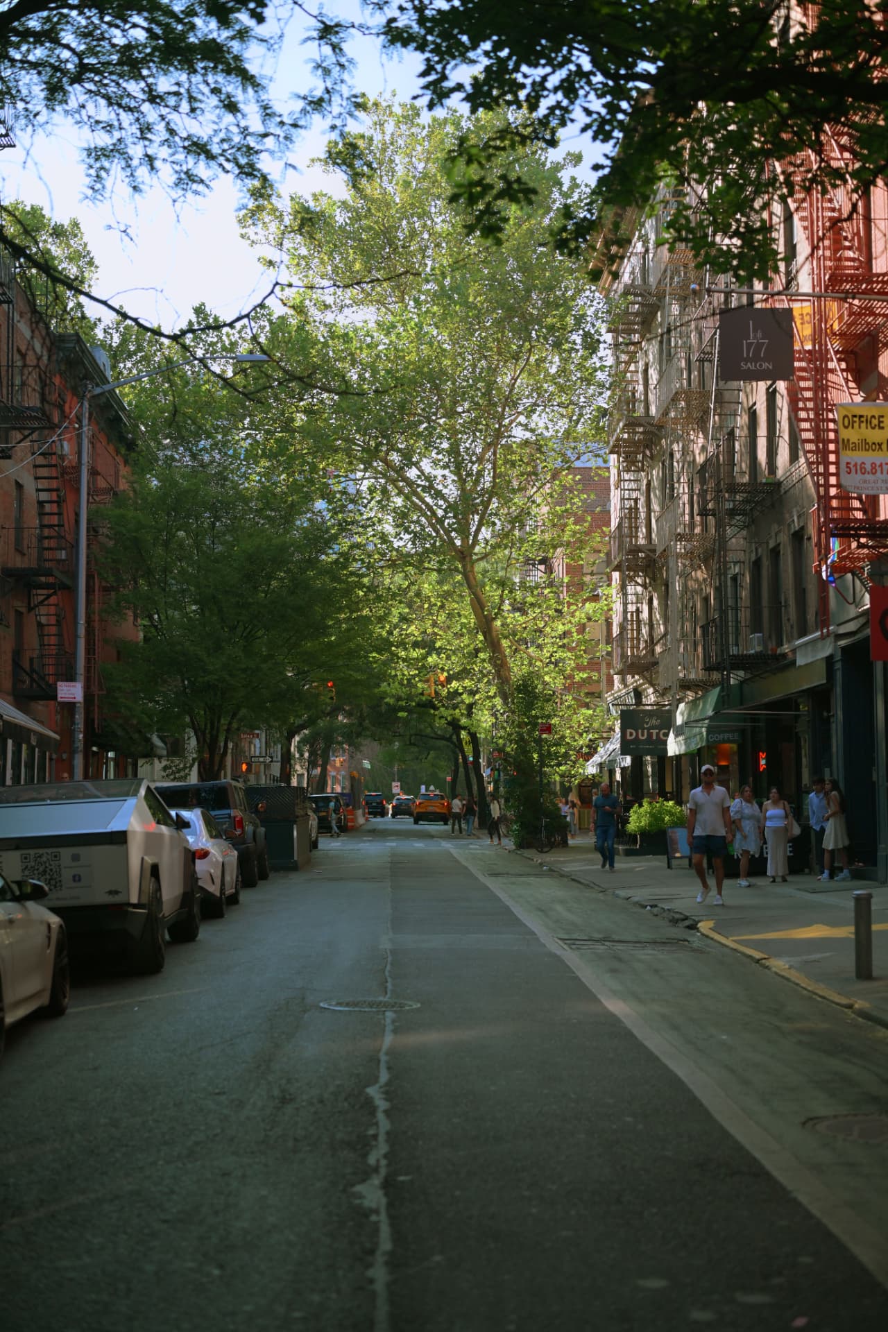 Tree-lined downtown Manhattan street with cast-iron buildings